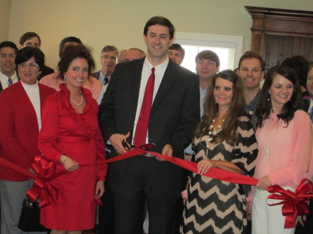 Dr. Dan Shell, center, and wife Mary Anna, left, cut the ribbon to officially open Shell Plastic Surgery in Oxford