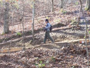 Much labor went into creating the trail and continues to go into maintaining them. Here, Michael Weldy and his chainsaw set out to keep the trail in order.