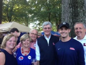 Members of the Yoste family with Governor Phil Bryant, who arrived after the rain.