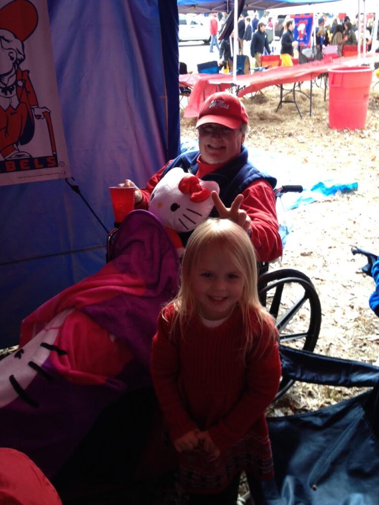 Members of the McCullough tailgating group always have a great time in the Grove. Here, Ashlynn Waddell takes care of Ron Knapp by letting him play with her Hello Kitty items.
