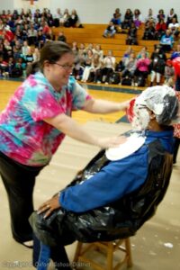 OMS Assistant Principal Yolanda Logan takes a pie full of whip cream to the face from OMS teacher Shara Minton in front of an OMS student assembly. Photo courtesy Oxford School District