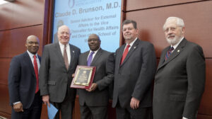 Trustee Shane Hooper, Dr. James Keeton, Vice Chancellor for Health Affairs and Dean, School of Medicine, honoree Claude D. Brunson, M.D., Senior Advisor for External Affairs to the Vice Chancellor for Health Affairs and Dean of the School of Medicine, “2105 Diversity Educator of the Year,” the University of Mississippi Medical Center, and Dr. Morris Stocks, Provost, The University of Mississippi, and Trustee Aubrey Patterson, President of the Board of Trustees.