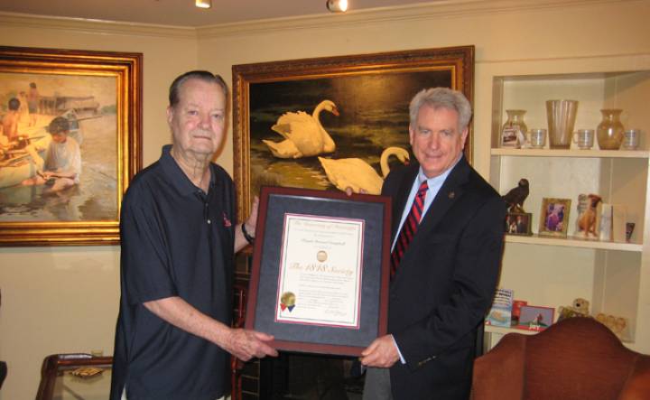 Alumnus Stewart Campbell of Austin, Texas, left, receives an 1848 Society certificate from UM Chancellor Dan Jones. Campbell has committed a major gift to fund scholarships, voicing his admiration for the Patterson School and his belief in accountancy degrees.