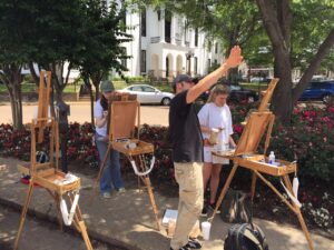 Matt Klos and University of Mississippi students paint landscapes on the Square.