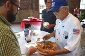 Mines serving pizza at PMQ's Slice of Americana. Photo by Andy Knef, PMQ Associate Editor