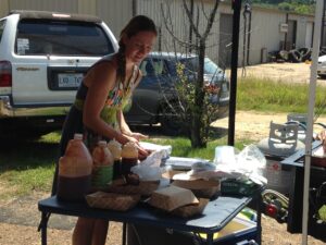 Meg Hayden prepares plates while Brad Hayden cooks for customers at the Farmer's Market. 