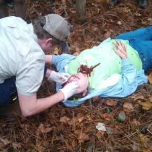 Dabney doing an EMT wilderness training scenario in the Paramedic Program at Northwest. 