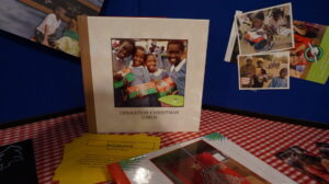 Mae Stone makes books of the children who receive the shoeboxes. 