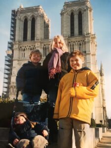 Ellen Lambert and brothers Ben, Sam, and Adam in front of Notre Dame Cathedral in Paris in 2001. The Lambert family lived in Paris for three years.  Courtesy of Ellen Lambert.  