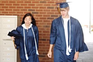 Mullen and Chen try on graduation gowns for OHS.