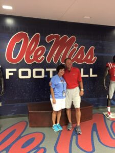 Photo courtesy Midge Bagwell as she poses with Ole Miss football head coach Hugh Freeze at 2015 Ladies Forum. 