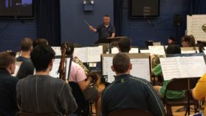 Bill DeJournett leads the rehearsal Tuesday, March 8.