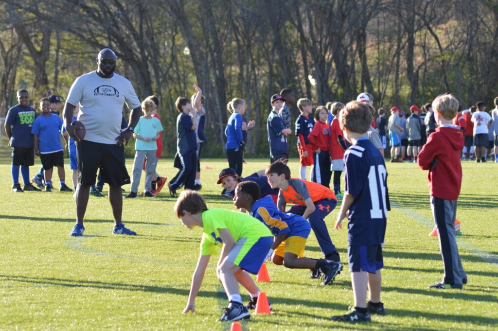 Local and collegiate football coaches help train the young campers.