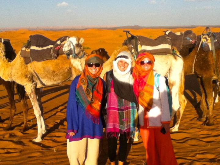 Miller Heiman (center) with two friends in the desert in Morocco. The camels were their source of transportation.