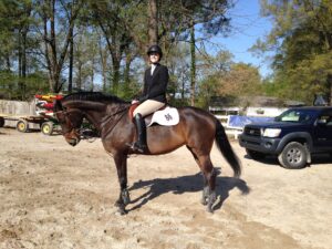 Roher on her horse, Sassy, after her first round of jumps in Germantown, Tennessee.