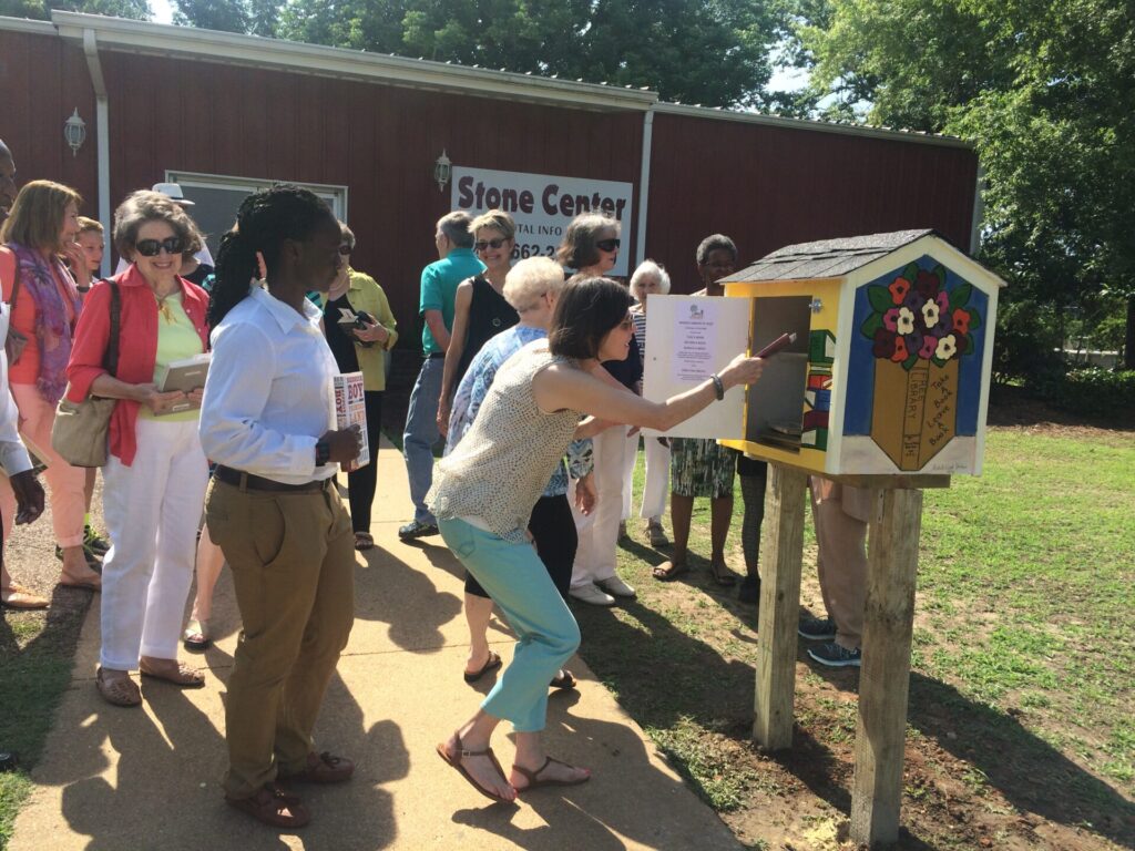 Round Table Book Club members fill up Little Free Library. 