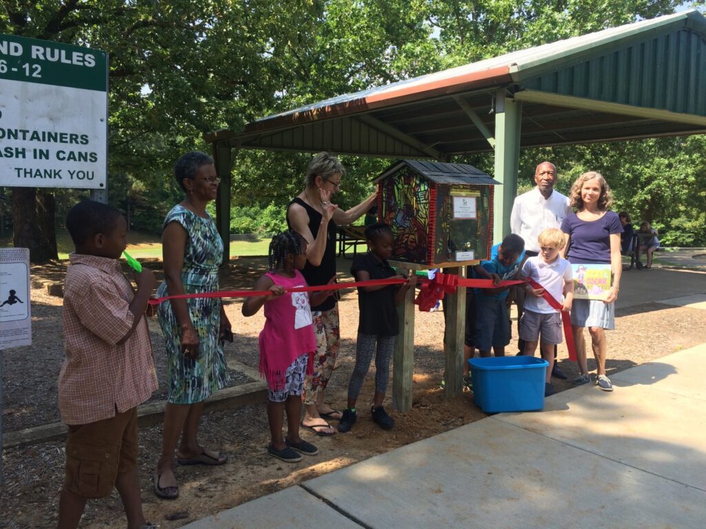 The children at Price Hill Park cut the ribbon for their new Little Free Library