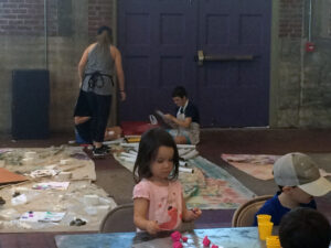 Andi Bedsworth along with volunteers oversee latest creations by the young campers. 