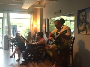 Dereck Brown plays the guitar at Mugg Cakes for Poeteats. 