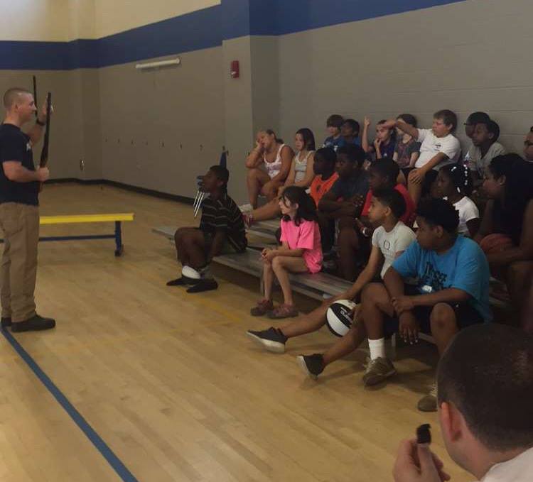 A police officer showed the campers what a firearm is and instructed them on its dangers and proper use. (Picture from Facebook.com/ Oxford MS Police Department) 