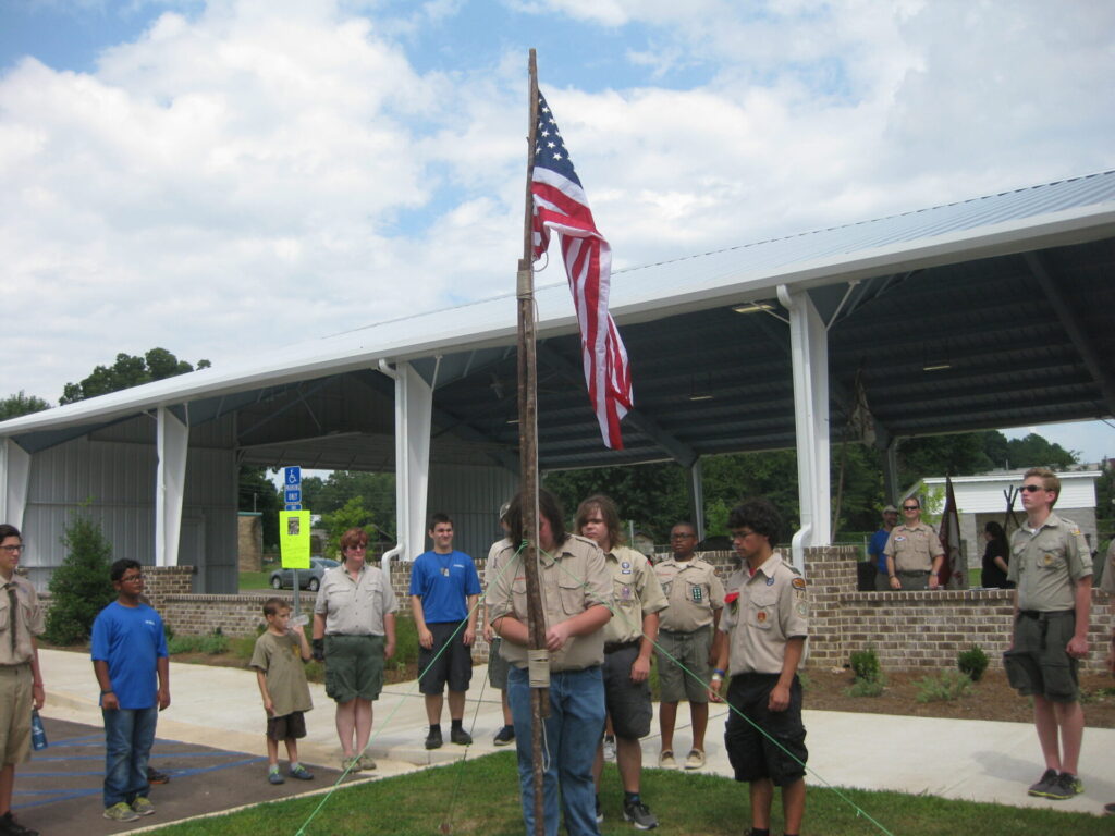 Scouts from Boy Scout Troops 144 and 146 and Cub Scout Pack 4 conduct a flag ceremony at the beginning of Sunday's Scouting demo at the Old Armory Pavilion on University Avenue.