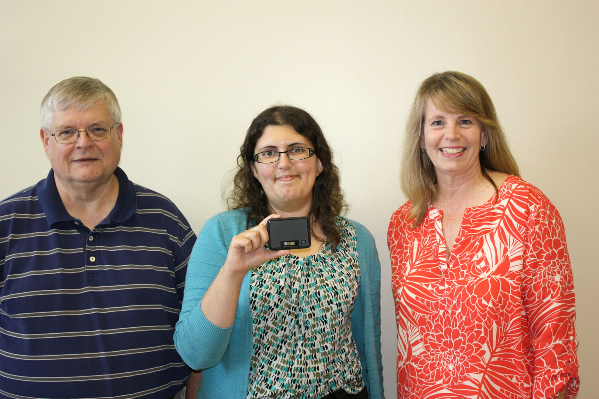 The Northwest Mississippi Community College library on the Senatobia campus is now offering Wi-Fi hotspots to checkout for students who have no internet access at home. Showing off one of the Wi-Fi devices available for check out is (left to right) Glenn McDowell, system administrator, Maya Berry, digital librarian and Maggie Moran, director of Learning Resources. (Photo by Allen Brewer, Northwest journalism student)