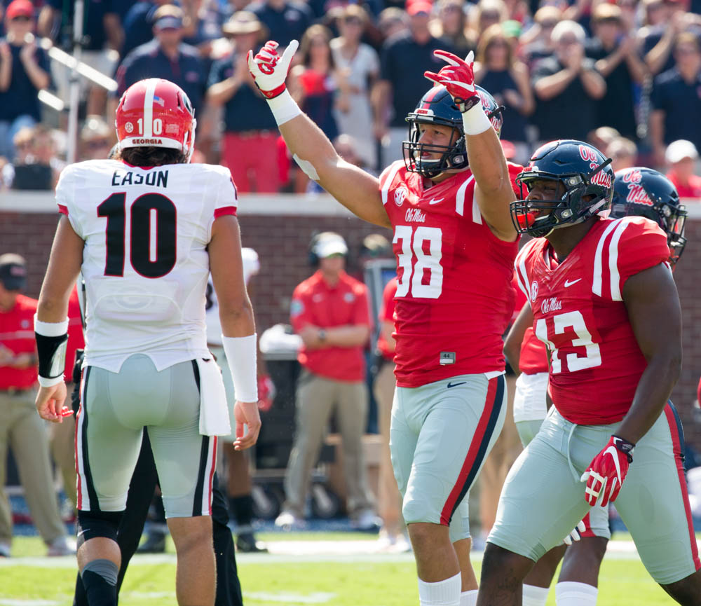 Ole Miss' John Youngblood encourages the student section after a successful stop as the Rebels take on the Georgia Bulldogs Saturday at Vaught-Hemmingway stadium.