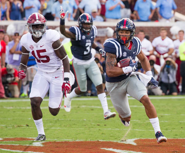 Ole Miss senior Evan Engram snags the reception and beats the tackle from Alabama's Ronnie Harrison at Vaught-Hemmingway stadium Saturday during the Ole Miss v Alabama game.