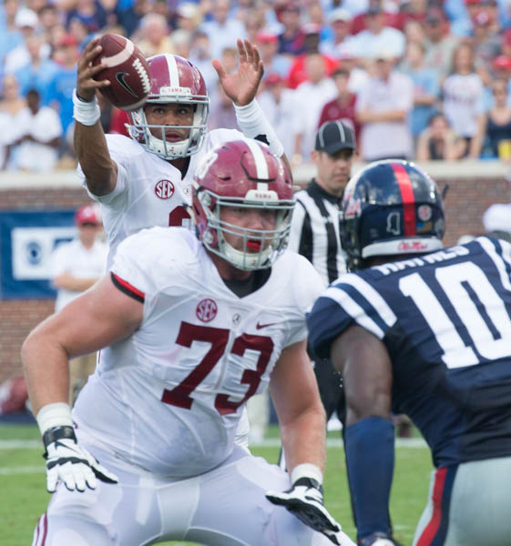 Alabama's quarterback Jalen Hurts takes a high snap as Jonah Williams (73) provides protection against Marquis Haynes at Vaught-Hemmingway stadium Saturday during the Ole Miss v Alabama.