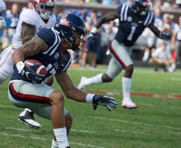 Ole Miss' Evan Engram completes the pass for a big gain.