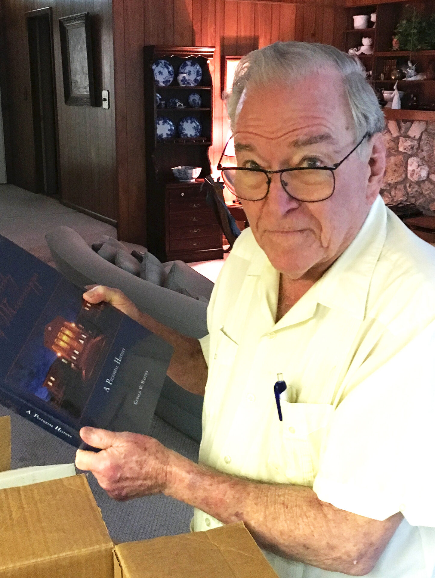 Dr. Creighton Wilson, at his home in Gainesville, Florida, opens a box of Ole Miss memorabilia sent to him from the UM Foundation in recognition of his many years of giving to the university.