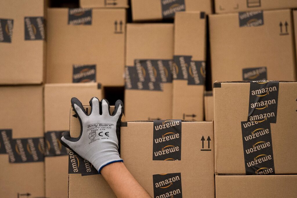 An employee loads a truck with boxes to be shipped at the Amazon.com Inc. distribution center in Phoenix, Arizona, U.S. on Monday, Nov. 26, 2012. Photographer: David Paul Morris/Bloomberg via Getty Images
