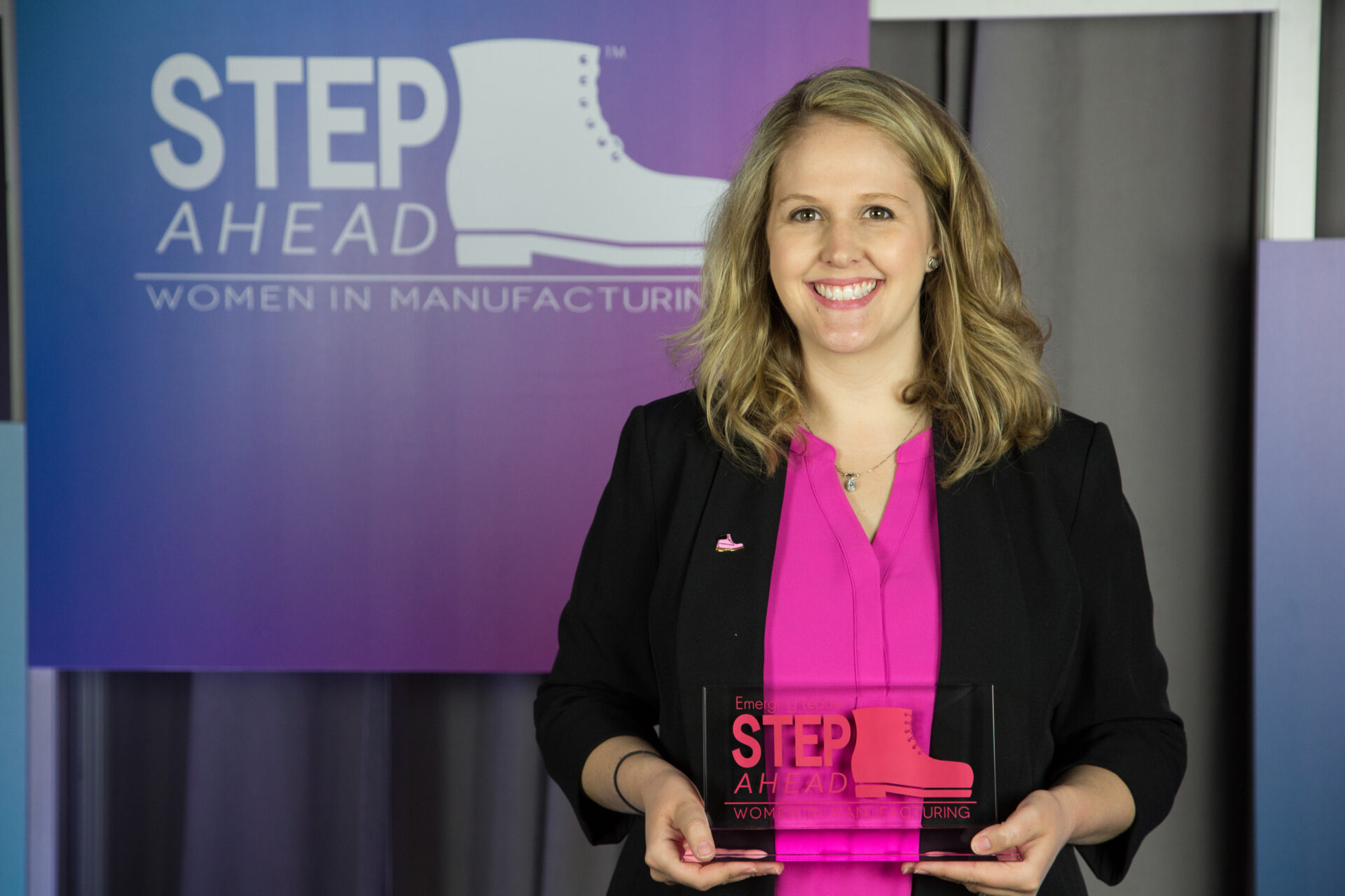 Six Sigma Black Belt Nichole Williams poses with her 2016 Emerging Leader Award. Photo courtesy of the National Assoc. of Manufacturer; Photo by Ian Wagreich