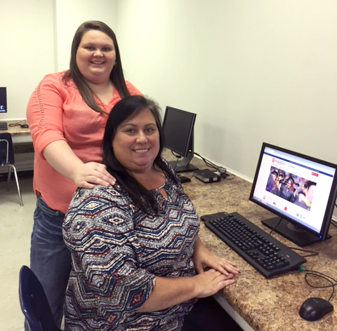 Sonia Thompson (seated) and daughter Jennifer, both of Grenada, are enrolled in college courses together this fall at the University of Mississippi at Grenada. The Thompsons are taking advantage of scholarships available to full-time employees and their children at the University of Mississippi Medical Center's Grenada hospital.