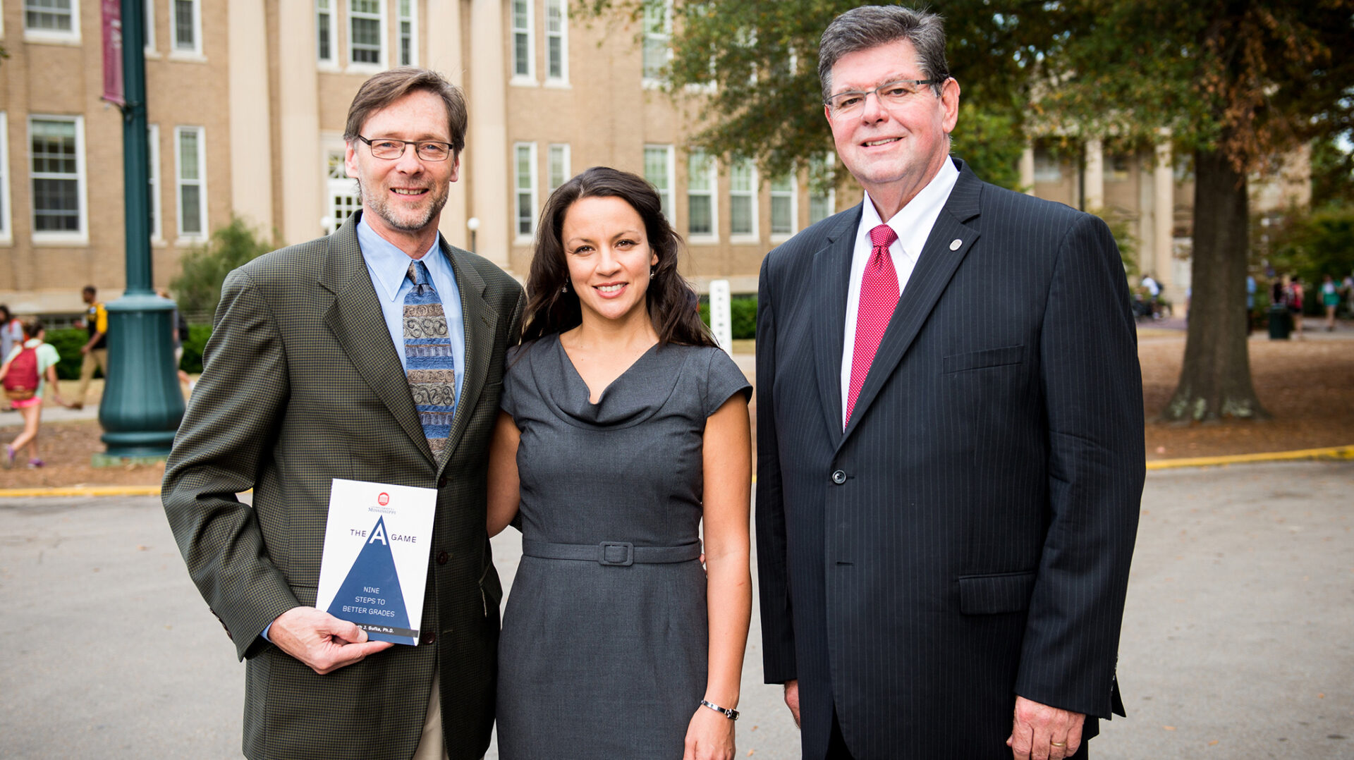UM professor Ken Sufka (left) and his wife, Stevi Self, have established a scholarship from royalties received from the publication of Sufka's book. UM Provost Morris Stocks (right) was instrumental in making the book required reading for all entering students. Photo by Bill Dabney