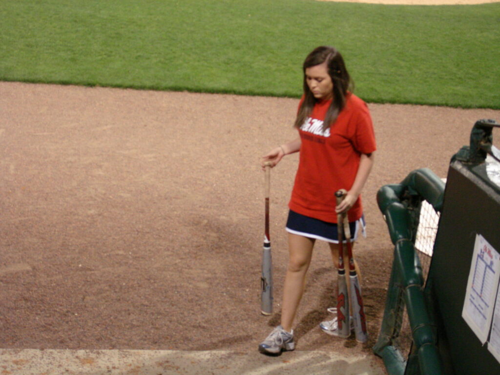 Taylor West carries the bats off the field. 