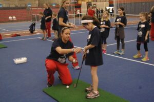 Sophomore Alison Hovatter gives tips on how to properly hold a golf club.