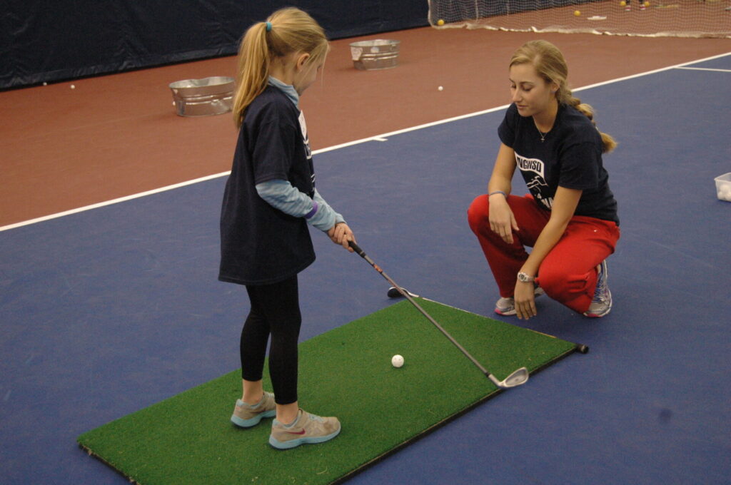 Sophomore Abby Newton observes some putting skills.