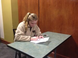 Laney Coker signs her lease at The Hub for her sophomore year.