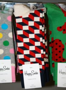 Men wear the unisex Happy Socks with loafers and women pair them with boots.
