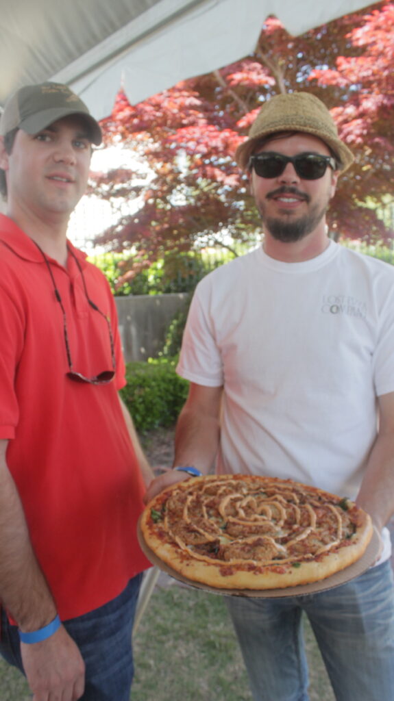 Preston Lott and Brooks Roberts of Lost Pizza Co. and their pie. 