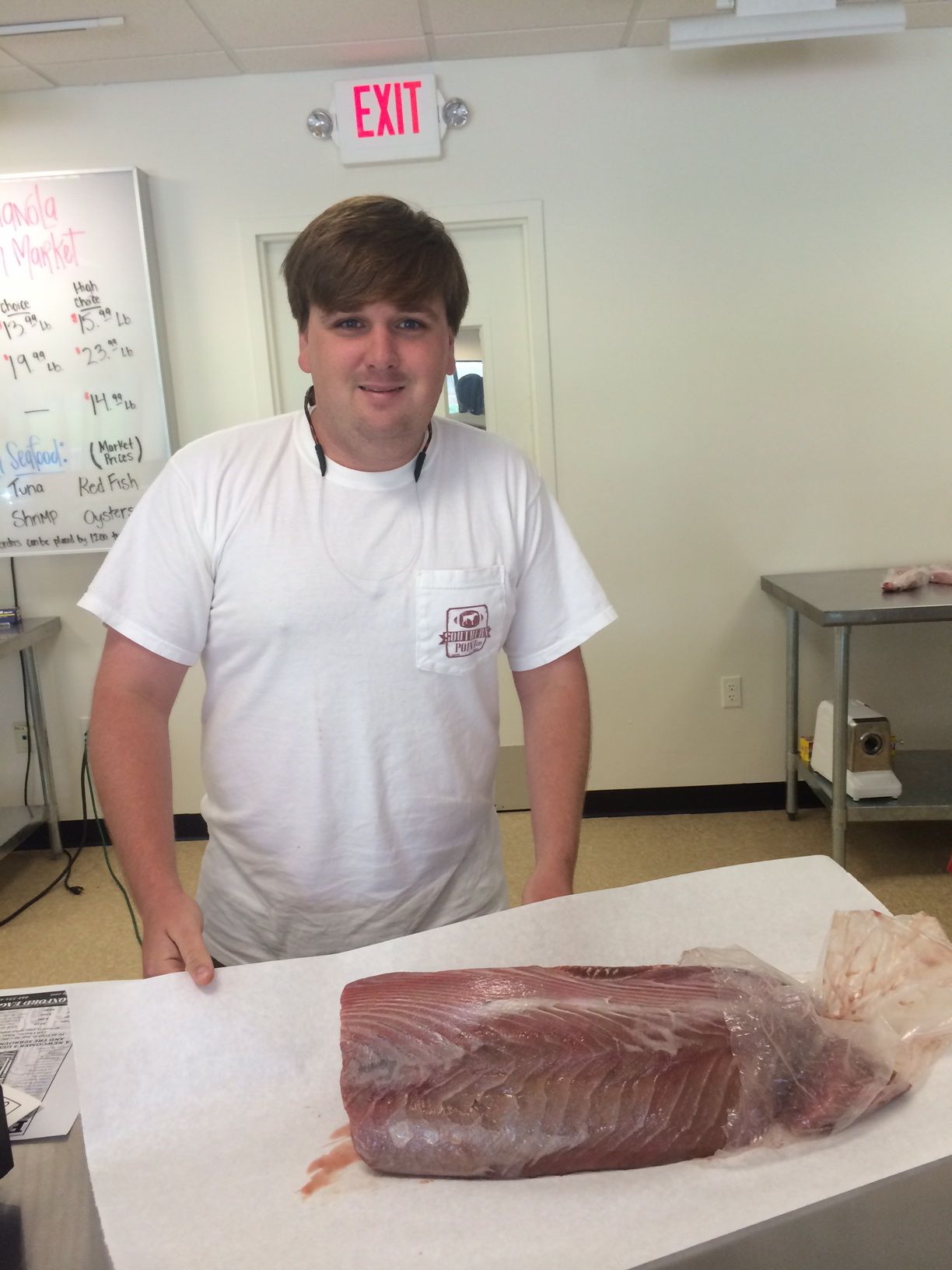 Indianola Fresh Market Owner Will Adams with a hefty slab of fresh tuna.