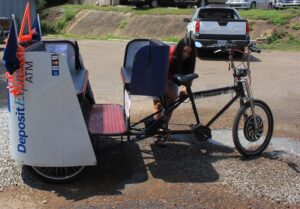 Ashley Hoffner prepares the rickshaw. 