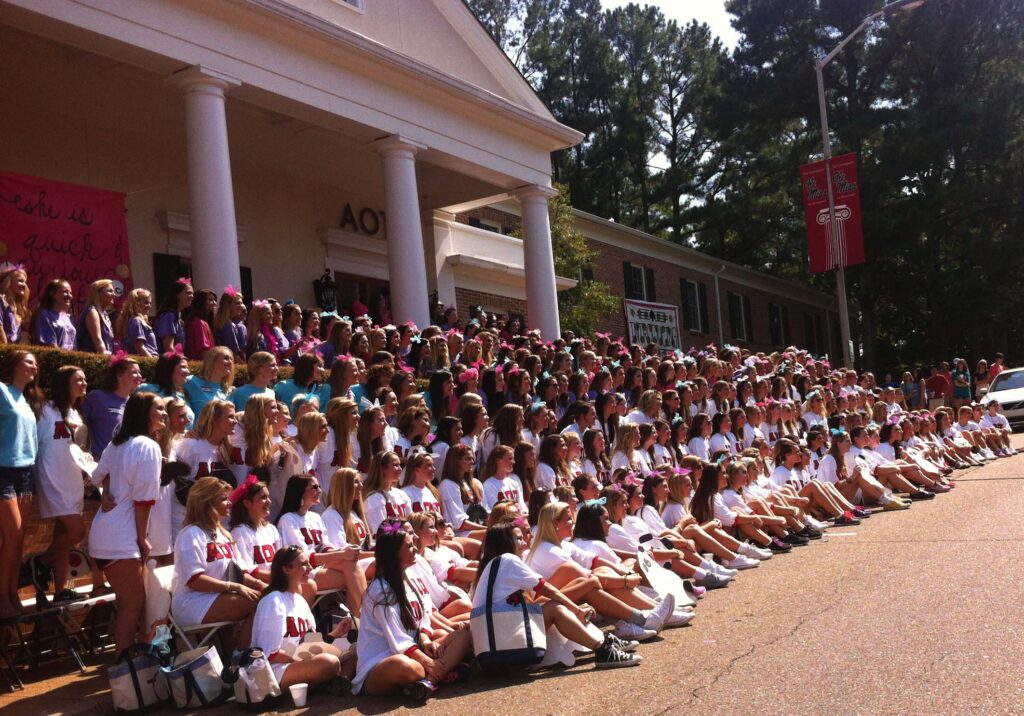 Alpha Omicron Pi with their pledges in white in front. 