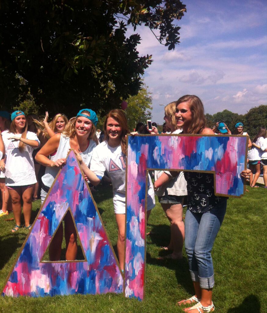Ladies pose with Delta Gamma letters.