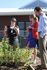 Good Food for Oxford Schools director Sunny Young takes two staff members on a tour of Della Davidson Elementary School's garden.