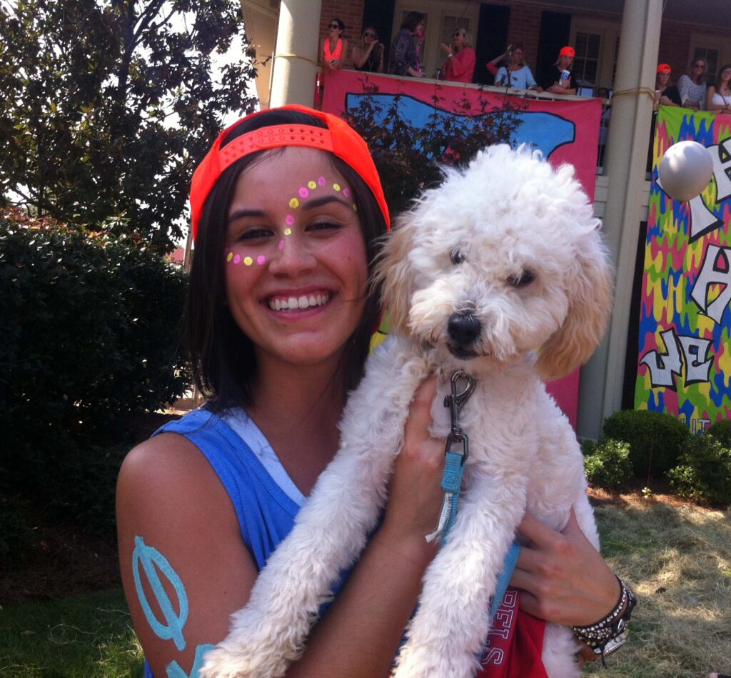 Nicole Villarreal poses with her dog at Phi Mu's Bid Day.