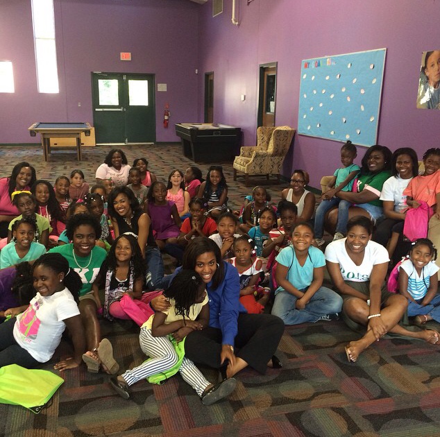 The AKA ladies with children at the Boys and Girls Club. 