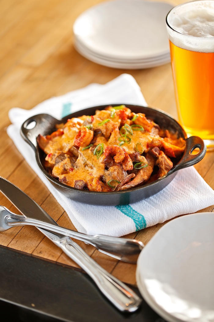 Besides authentic po'boys, guests can expect super-comforting dishes such as this skillet of andouille, crawfish, and pimento cheese.