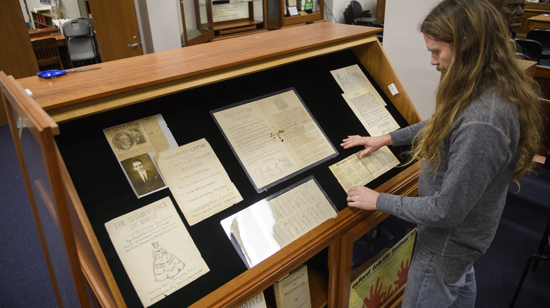 Greg Johnson arranges a new exhibit featuring the Mississippi Bicentennial at the Archives and Special Collections in J.D. Williams Library. Photo by Thomas Graning/Ole Miss Communications